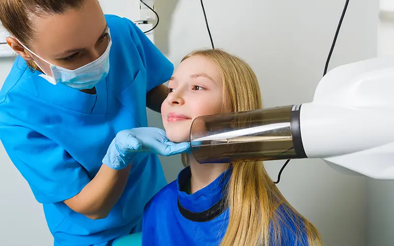 A young patient receiving a dental x-ray