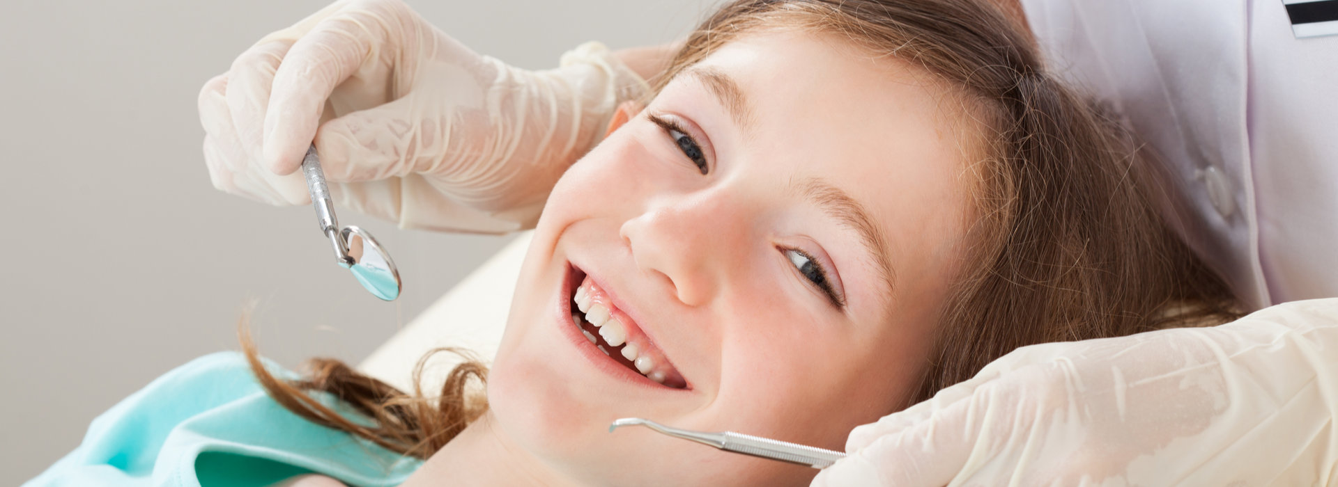 A child is smiling after Dental Sealants.