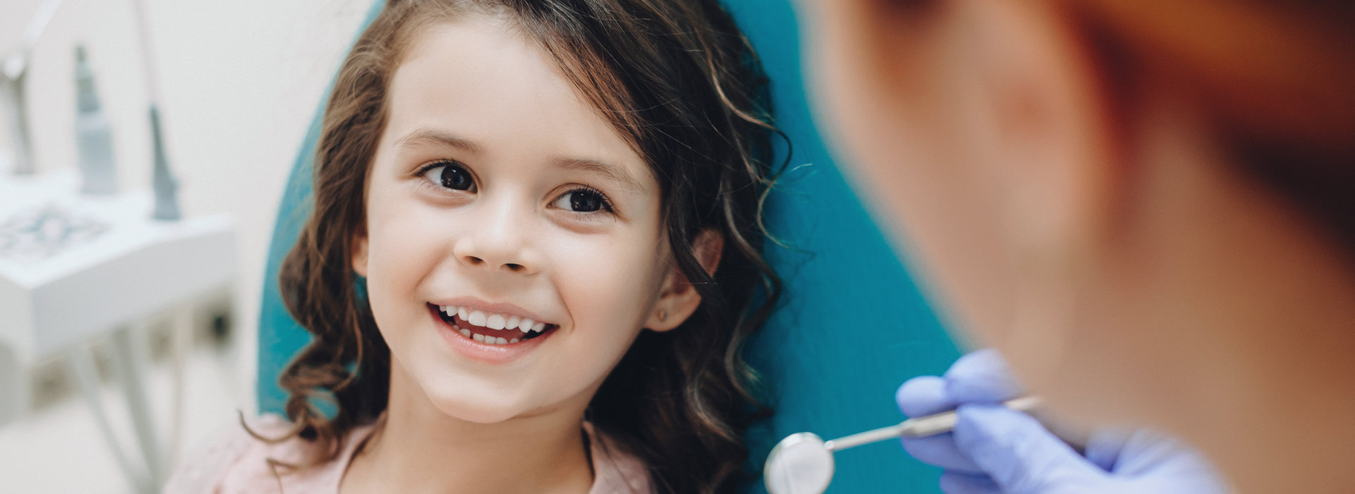 A child is smiling after Periodontal Care.