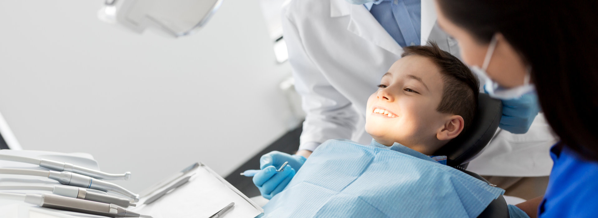 A child is smiling after Oral Cancer Screening.