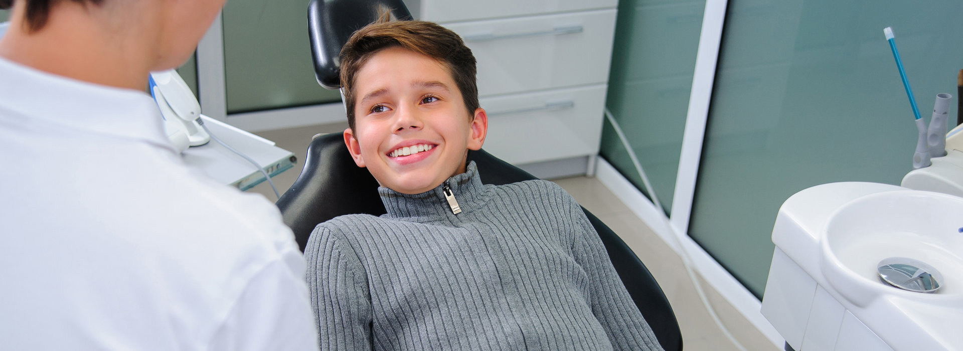 A child is smiling after Tooth Extraction.