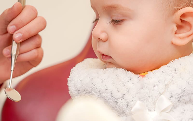A baby having an oral exam